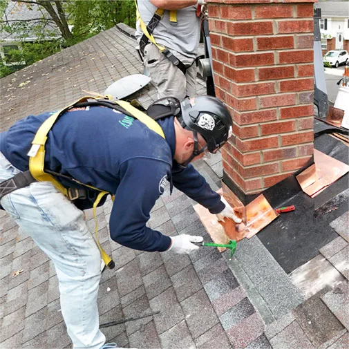Step and counter flashing built into a new chimney at the roofline